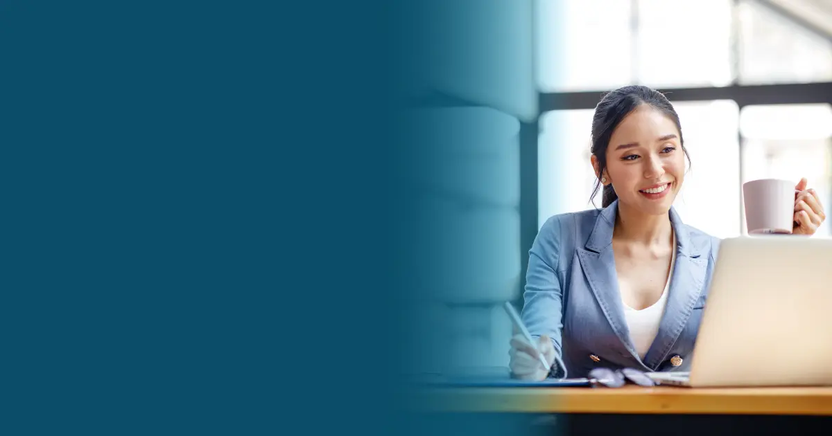 Woman using a laptop and smilling